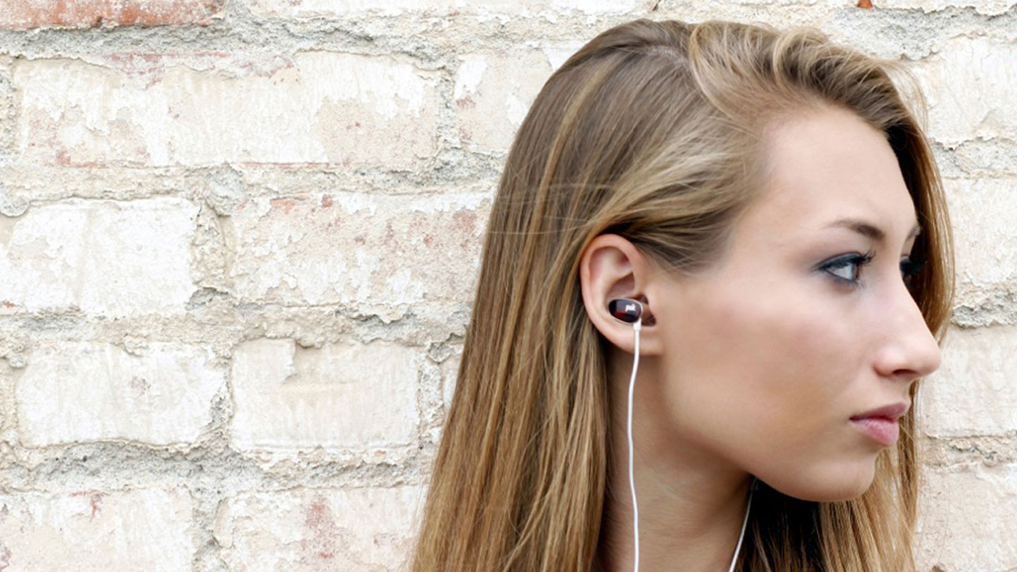 Girl listening on Spooners earbud